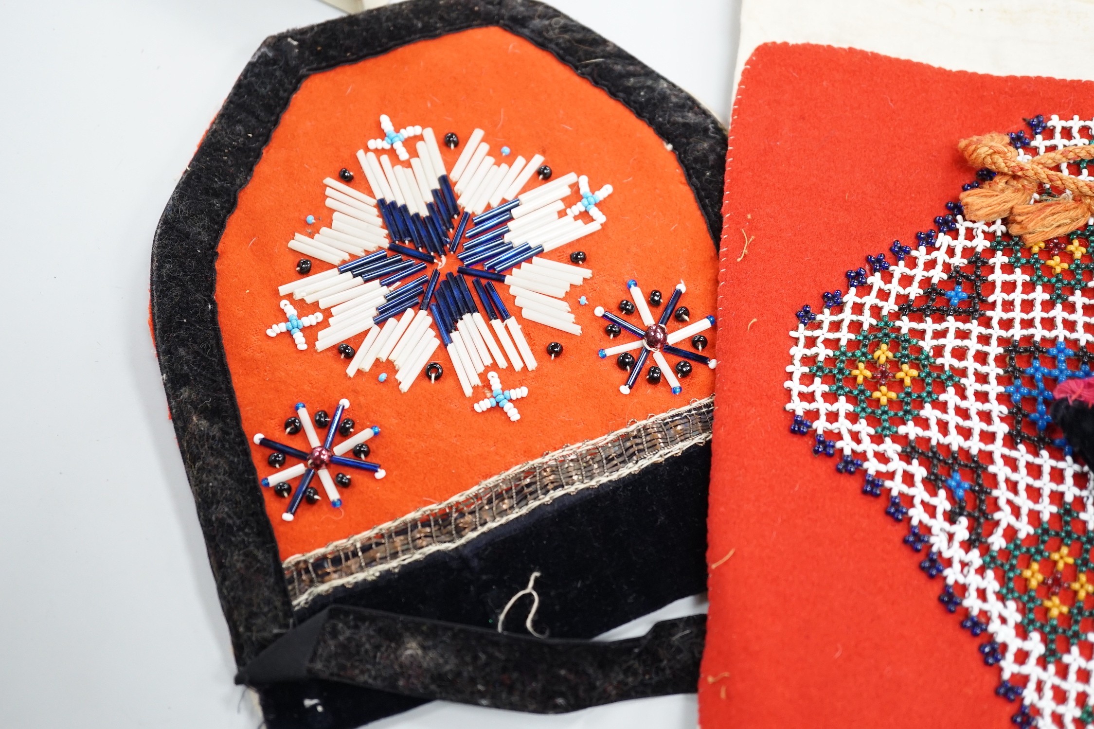 A collection of 19th century Scandinavian beadwork, worked in white and coloured geometric designs on red wood backing, (5)
